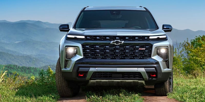 Front view of a silver Chevrolet Traverse on a grassy path