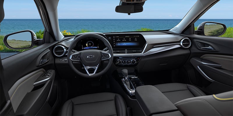 Modern black interior dashboard of a Chevrolet Trax with digital displays.